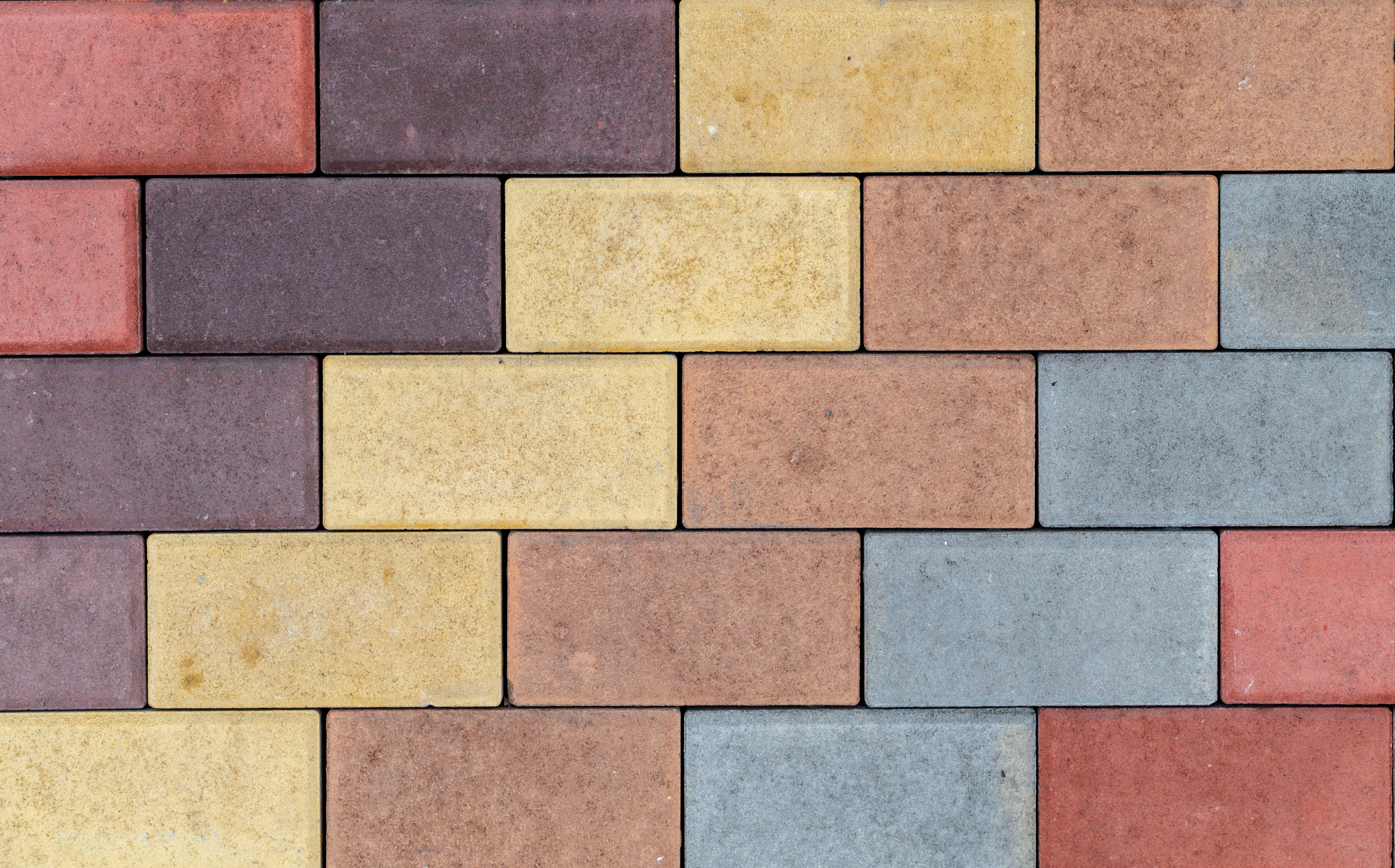 Texture of bricks of different colors. Facing material under imitation of a brick wall for construction. Example at the exhibition.